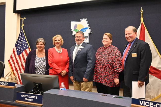 The current County Commissioners. From left, Pam Richardson, Kim Carney, Andy Dance, Leann Pennington and Greg Hansen. (© FlaglerLive)