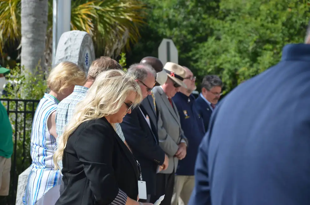Flagler County officials and several members of the local clergy from various denominations stood almost shoulder to shoulder at today's ceremony commemorating lives lost to the covid pandemic, the first such government commemoration in the county. (© FlaglerLive)