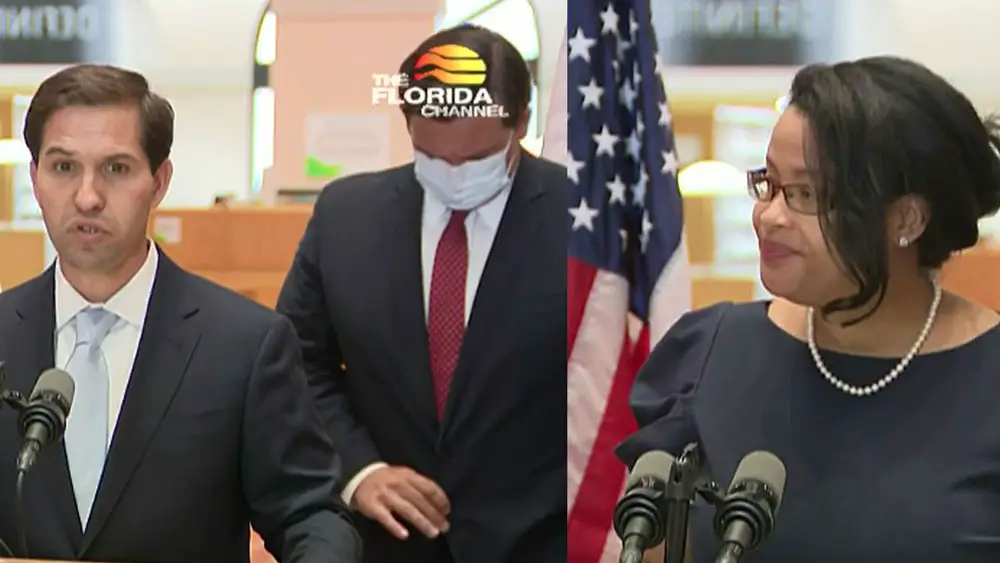 John Couriel and Renatha Francis at today's press conference where Gov. Ron DeSantis, center, announced the Supreme Court picks. (© FlaglerLive via Florida Channel)
