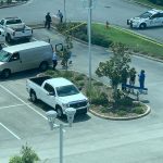 The scene at the courthouse parking lot, within view of the Government Services Building and of courtrooms, some of them in session, in late morning as the Medical Examiner was preparing to remove the victim. (© FlaglerLive)