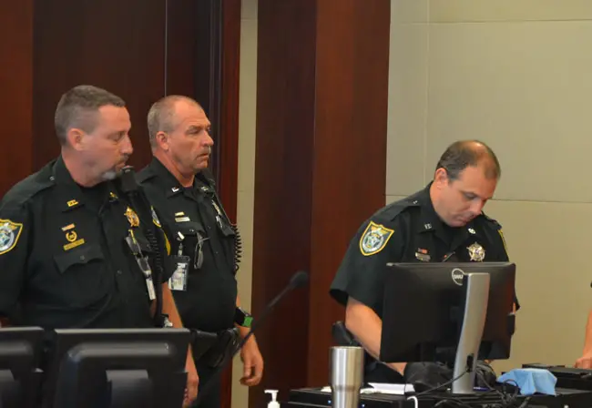 Three of the Flagler County Sheriff's deputies assigned to courthouse duty that were named in internal inquiries, and that led to a shake-up at the courthouse: from left, Sgt. John Bray, who lost his position as a supervisor of courthouse bailiffs and was assigned desk duty at the Palm Coast Precinct, Jonathan Freshcorn, whose duties are unchanged, and Jeffrey Puritis, who has twice been disciplined since November and was re-assigned, a few weeks ago, to road patrol. He had been assigned to Judge Dennis Craig. (© FlaglerLive)