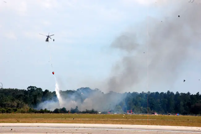 Flagler County's Fire Flight and firefighters battled the blaze at the Flagler County Airport after the Yak's crash last March. (© FlaglerLive)