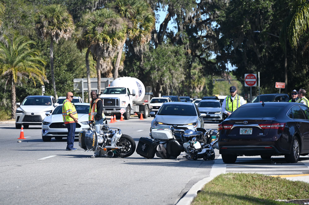 The Toyota Avalon to the right crashed into two Flagler County Sheriff's deputies on motorcycles late this morning, by the entrance to Wawa on Palm Coast Parkway westbound. (© FlaglerLive)