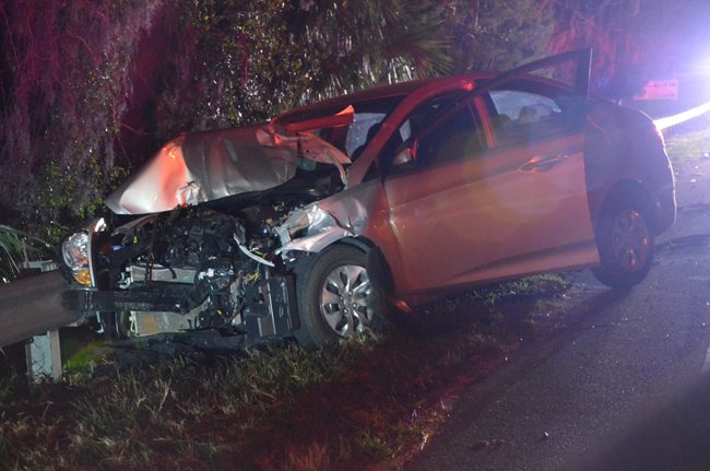 A woman at the wheel of this compact car apparently never saw the pick-up truck stopped at State Road 100 and County Road 35, waiting to make a turn. She crashed into the truck, catapulting it in the way of another, incoming pick-up. (c FlaglerLive)