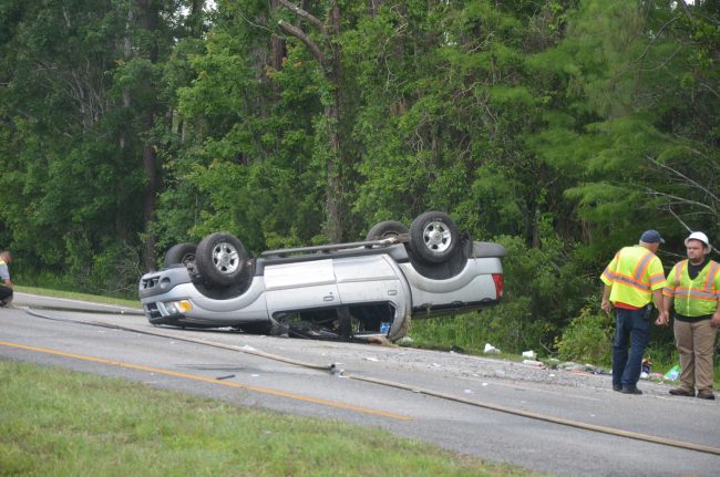 The Ford Escape ended on its roof just past the White Eagle Lounge at around 11:40 this morning. (c FlaglerLive)