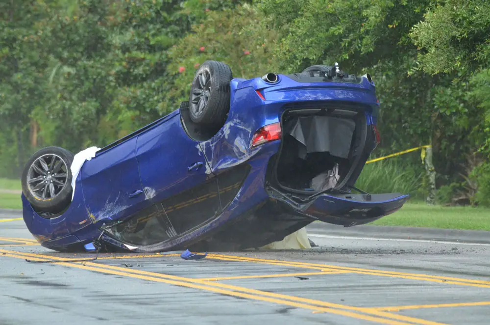The Accura flipped on Royal Palms Parkway just past Point Pleasant Drive at midday Monday. (© FlaglerLive)