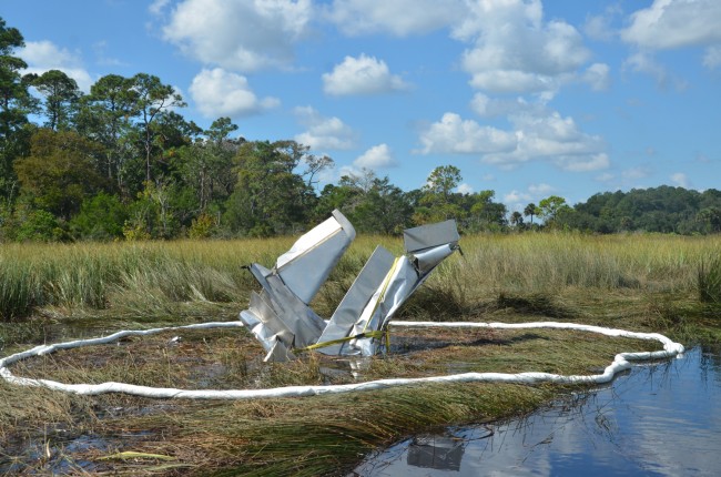 Rescuers and recovery personnel have been unable to pull Ray Miller's experimental plane from the muck in Pellicer Creek since it crashed last Friday. The plane is seen here this morning. Click on the image for larger view. (c FlaglerLive)