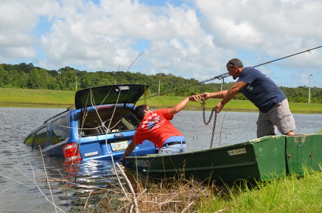 Roger's Towing's crew pulled out Carl L:aundrie's SUV from the pond at 3:15 p.m. Click on the image for larger view. (c FlaglerLive)