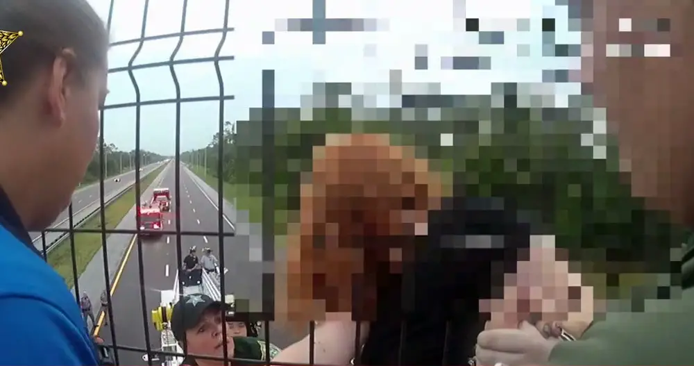 Flagler Sheriff's deputy Crista rainey, near the center on the ladder truck, negotiating with the girl. (© FlaglerLive via FCSO video)
