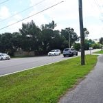 There is a crossing point from the footpath at Royal Palms Parkway and Point Pleasant, but no crosswalk and no signs cautioning for pedestrian safety, though the crossing point is frequently used by P-Section residents, on foot and on bicycles. (© FlaglerLive)