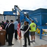 It was all pomp and crushed glass at a demonstration of Flagler Beach's "big Blue" glass-recycling machine this morning on the grounds of the city's sanitation department. (© FlaglerLive)