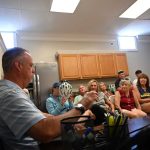 Flagler Beach Police Chief Matt Doughney, left, explaining the city's new juvenile curfew to the audience at Commissioner Scott Spradley's "Coffee with the Commissioner" event last Saturday. (© FlaglerLive)