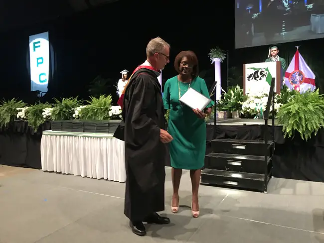 Carmen Gray receiving an honorary degree for her late son Curtis from Superintendent Jim Tager Thursday evening at the Ocean Center. Gray would have been part of Flagler Palm Coast High School's Class of 2019. (Jason Wheeler)