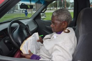 Daisy Henry, a pastor, reading her Bible on Election Day in 2014, when she last served on the Bunnell commission. (© FlaglerLive)