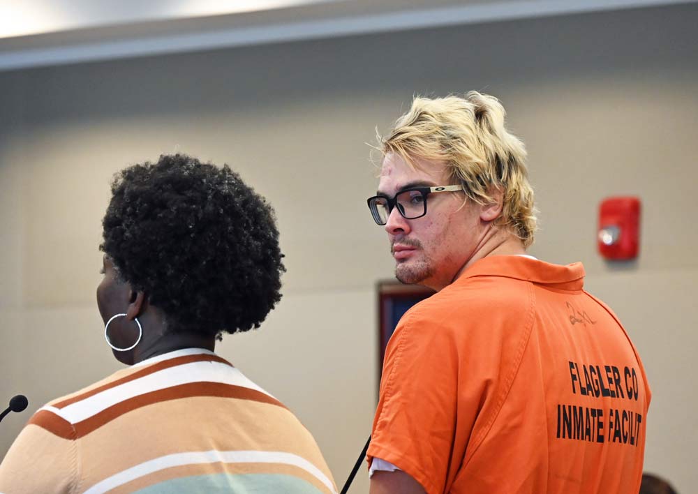 Dacotah Clarke speaking with his attorney, Regina Nunnally, at his contempt hearing on Monday before Circuit Judge Terence Perkins. (© FlaglerLive)