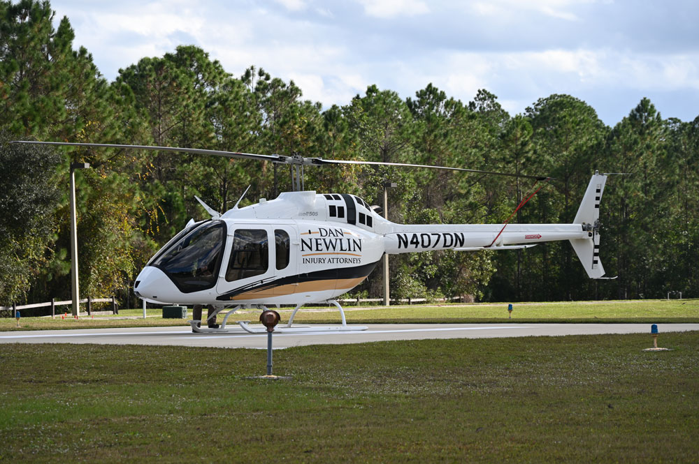 The Dan Newlin Bell 505 helicopter during one of its many visits to Flagler County. It has been acquired by the Flagler County Sheriff's Office and will have new colors and a new N-Number, tailored after Sheriff Rick Staly's dispatch number. (© FlaglerLive)
