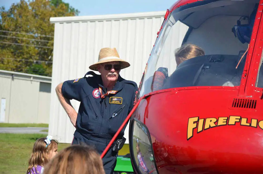 Dana Morris showing FireFlight to children at the Flagler County airport in 2018. (© FlaglerLive)