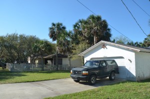 Dana Mulhall's Bronco, the day after he was killed,  as he had left it on March 14, 2012 in his driveway. His front door is around the garage, closer to the Miller property. Click on the image for larger view. (© FlaglerLive)