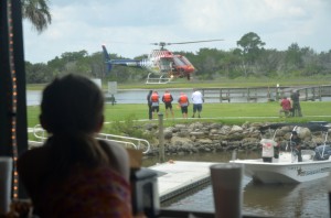 8-year-old Daniela, visiting Bings Landing with her family from South Florida, was among the spectators to an unexpected show from the deck of Captain's BBQ. Click on the image for larger view. (© FlaglerLive)