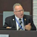 The Palm Coast City Council's Ed Danko hectoring Chief Sustainability and Resiliency Officer Maeven Rogers at Tuesday's meeting, before turning to argue with Mayor David Alfin, who brought Danko under control. (© FlaglerLive via Palm Coast TV)