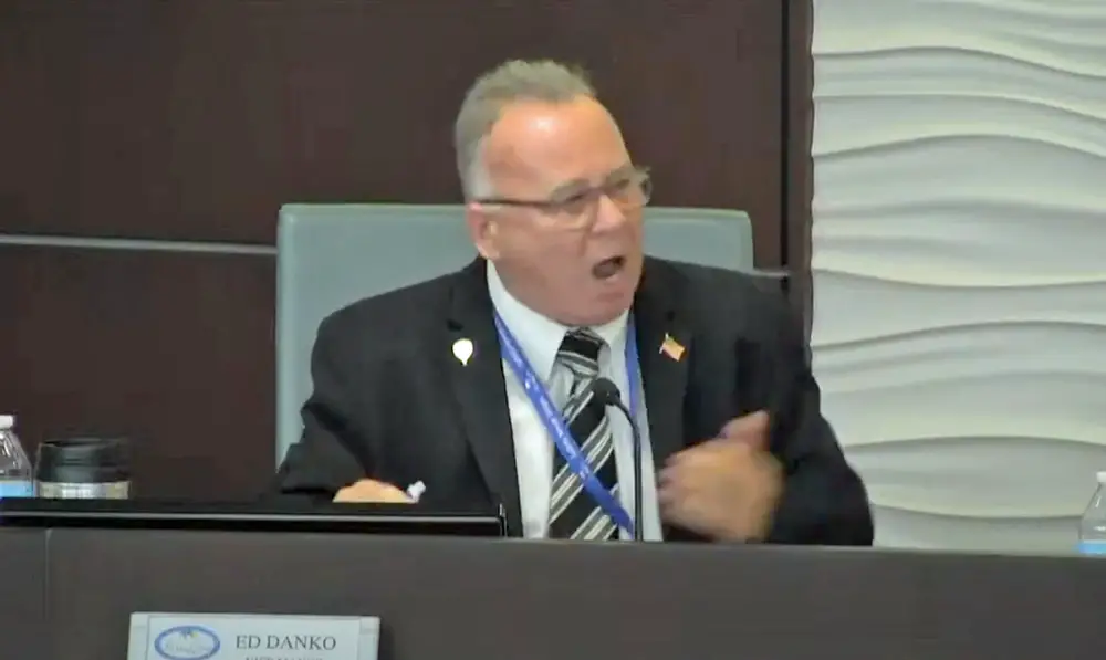 The Palm Coast City Council's Ed Danko hectoring Chief Sustainability and Resiliency Officer Maeven Rogers at Tuesday's meeting, before turning to argue with Mayor David Alfin, who brought Danko under control. (© FlaglerLive via Palm Coast TV)