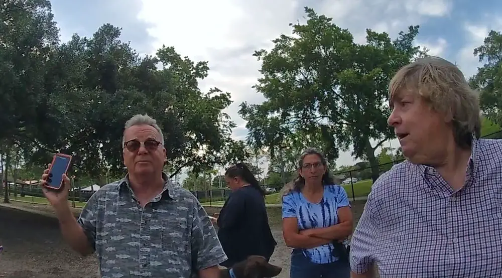 Palm Coast City Council member Ed Danko and Shirley Anderson, a former sheriff's deputy, speaking with a Flagler County Sheriff's deputy investigating the dog-biting incident at Holland Park on April 13. (© FlaglerLive via FCSO)