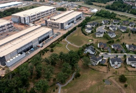 An Amazon data center sits next to a neighborhood in northern Virginia.