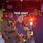 From left, Flagler County Sheriff's Deputy Marcus Dawson, Palm Coast Fire Department Firefighter-Paramedic Kalin Graham, the 3-year-old boy, and his father, Kevin Farris. (FCSO)