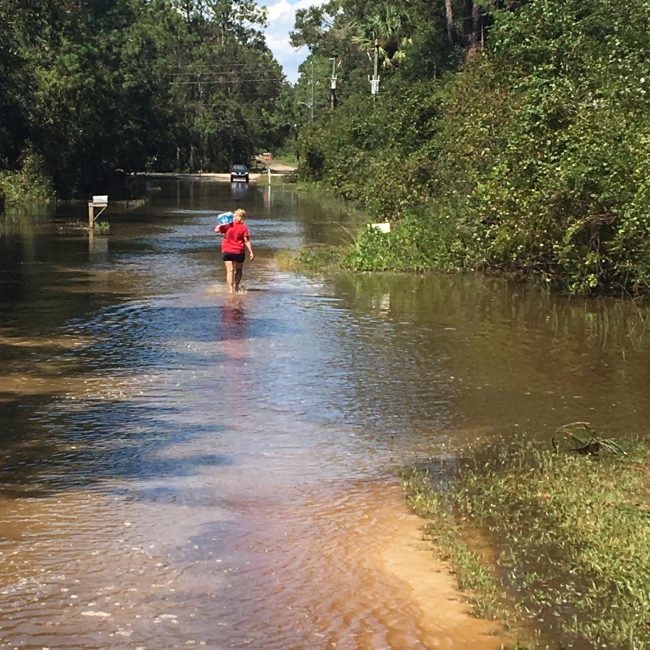 In Daytona North, also known as the Mondex, where waters are still dangerously high, Flagler County Fire Rescue personnel from Station 71 today delivered water and meals ready to eat to residents stranded and without power. (c FlaglerLive)