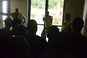 Chief Paul Bovino, left, Sgt. Ryan Emry and Sgt. Chris Ragazzo during one of the afternoon's debriefings. Click on the image for larger view. (© FlaglerLive)