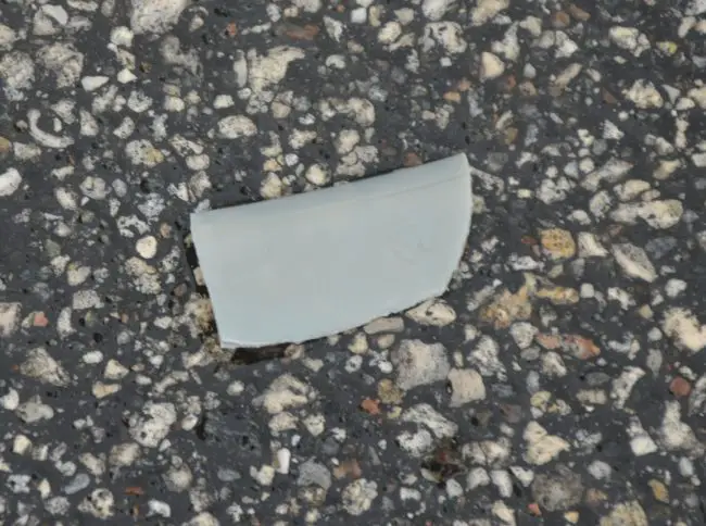 A piece of debris believed to be from the Jeep that struck the victim, indicating the color of the Jeep authorities are now seeking to find in this morning's hit and run. Click on the image for larger view. (© FlaglerLive)