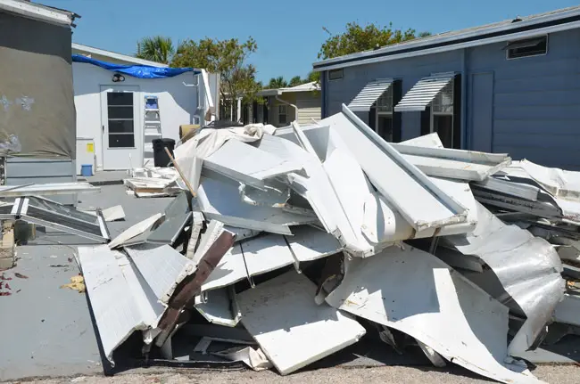 Piled up debris at Surfside Estates in Beverly Beach. (© FlaglerLive)