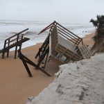 An elaborate deck and walkover at the south end of Flagler Beach was in pieces after this morning's high tide, the dunes around it significantly eroded again after the Department fo Transportation only last week had replenished the sands. (© FlaglerLive)