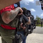 Isaac Malone Lewis making his way to the SWAT team after he put down th weapon he'd held against his head for almost two hours in a stand-off on Burning Eber Lane in Palm Coast Monday. The still is from a sheriff's deputy's body cam footage.