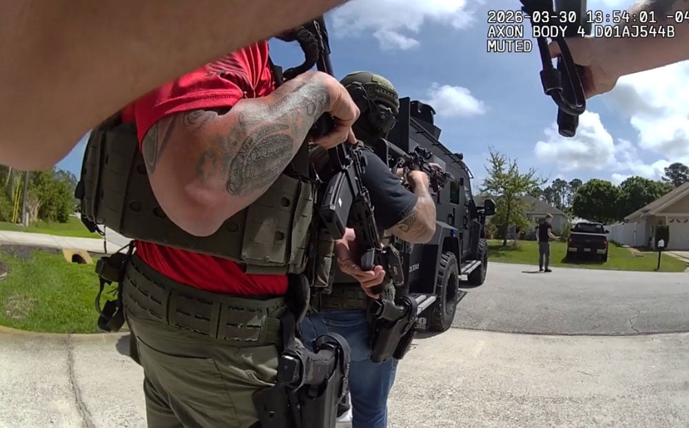 Isaac Malone Lewis making his way to the SWAT team after he put down th weapon he'd held against his head for almost two hours in a stand-off on Burning Eber Lane in Palm Coast Monday. The still is from a sheriff's deputy's body cam footage.