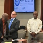 At the defendant's table after the jury was seated and the excused jurors were filing out. From left, defense attorners Junior Barrett and Anthony Eric Leonard, and Jermaine Williams Sr. (© FlaglerLive)