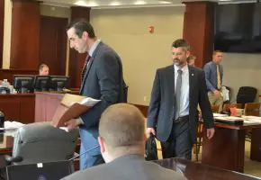 The prosecution team: Assistant State Prosecutors Jason Lewis, left, and Joe LeDonne, with Mark Lewis, seated and his back to the camera. (© FlaglerLive)