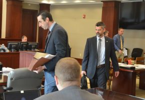 The prosecution team: Assistant State Prosecutors Jason Lewis, left, and Joe LeDonne, with Mark Lewis, seated and his back to the camera. (© FlaglerLive)