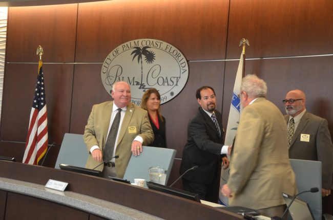 DeLorenzo welcoming Bob Cuff to the council in 2016, with Mayor Jon Netts and Council members Heidi Shipley and Steven Nobile. (© FlaglerLive)