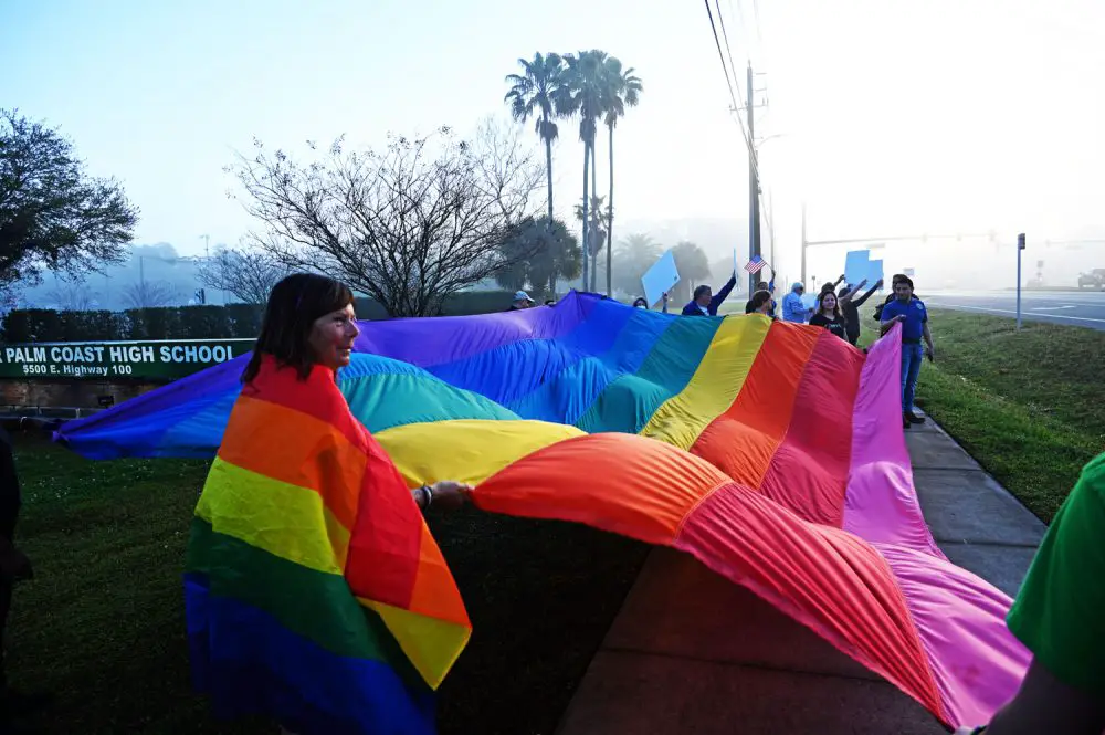 Demonstrators protesting the law dubbed "Don;t Say Gay" outside of Flagler palm Coast High School in March. (© FlaglerLive)