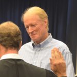 Dennis McDonald at his wife's swearing in for a school board seat four years ago, as a circuit judge was administering the oath. (© FlaglerLive)