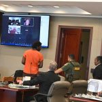 Brendan Depa, in the orange shirt, arriving for a hearing in court last June, before his transfer to the Flagler County jail. (© FlaglerLive)