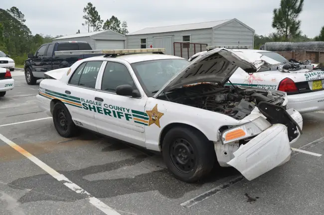 Flagler County Sheriff's deputies were involved in two crashes in five days between last Thursday and Monday. In the foreground, the cruiser that was involved in a collision with a motorcyclist on Seminole Woods Boulevard last week, and behind it, the cruiser involved in Monday's collision with a pick-up truck driver on U.S. 1. (c FlaglerLive)