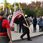 A Flagler County Sheriff's deputy at a protest outside the Government Services Building before a School Board meeting two years ago. It's been a bit calmer since. (© FlaglerLive)
