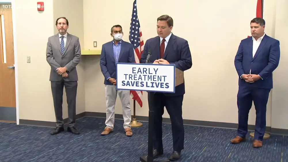 Gov. Ron DeSantis appearing at Daytona State College's Palm Coast campous this morning, with Sen. Travis Hutson, right. (© FlaglerLive via TampaBay 10)