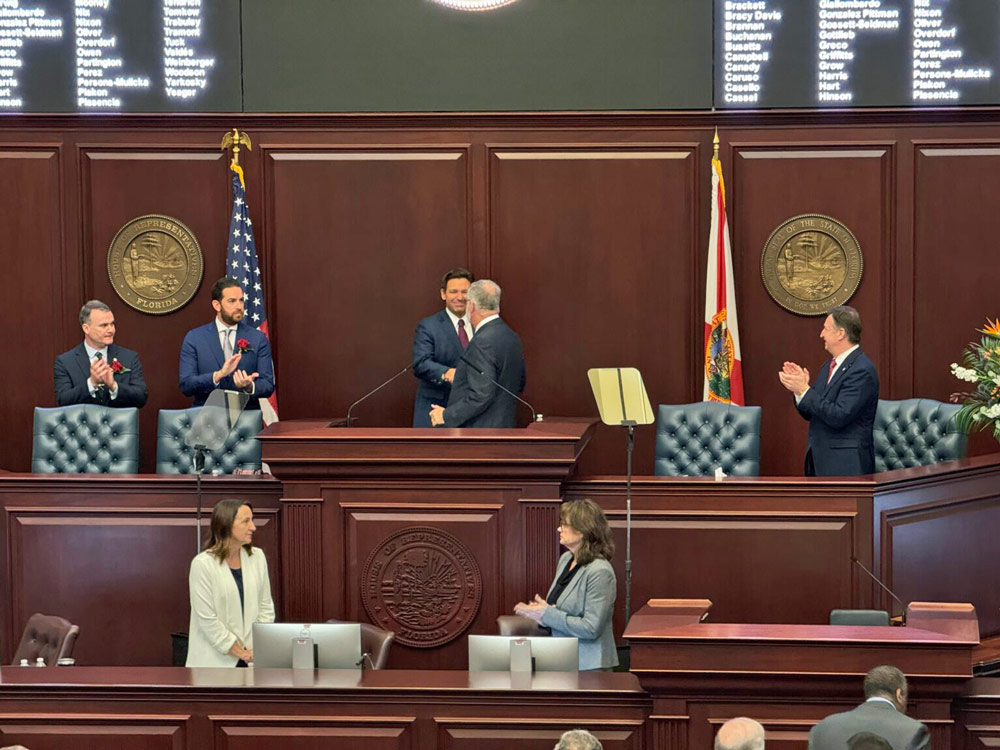Gov. Ron DeSantis, Senate President Ben Albritton, and House Speaker Daniel Perez stand in front of a joint session of the Florida Legislature to hear the governor’s State of the State address on March 4, 2025. (Photo by Jay Waagmeester/Florida Phoenix)