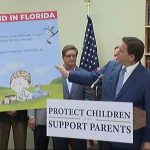 Gov. Ron DeSantis holds a large print of a children’s book about a transgender kid on March 28, 2022 Credit: screenshot/Florida Channel