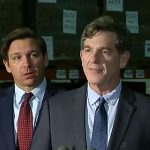 Gov. Ron DeSantis and Surgeon General Scott Rivkees in a rare joint appearance at the beginning of the coronavirus pandemic, on March 13, 2020, in an image from a Florida Channel video. DeSantis at his news conferences would push Rivkees aside for the remainder of the pandemic. (© FlaglerLive via Florida Channel)