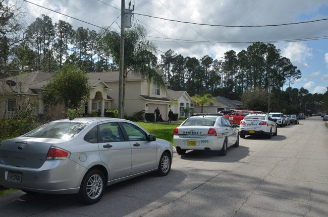 The scene in front of April Descartes' home in Palm Coast's R Section, a few hours after she was found dead. (© FlaglerLive)