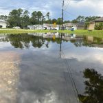 Swales are designed to flood if necessary. But this swale in Palm Coast's P Section, on Sept. 8, a full month before Hurricane Milton dumped upwards of 16 inches of rain on the city, is an indication of how saturated grounds had been ahead of Helene and Milton. Yet the system functioned, preventing flooding into homes except for a handful. (© FlaglerLive)